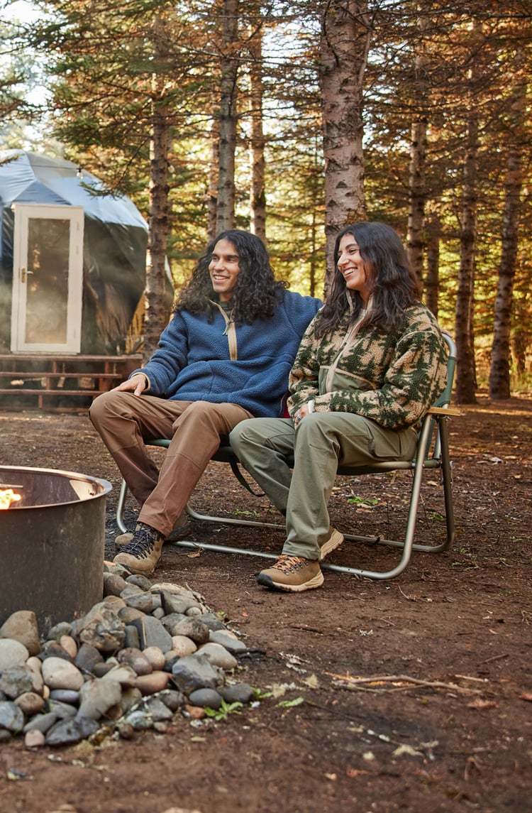 a group of friends shares a fire outdoors