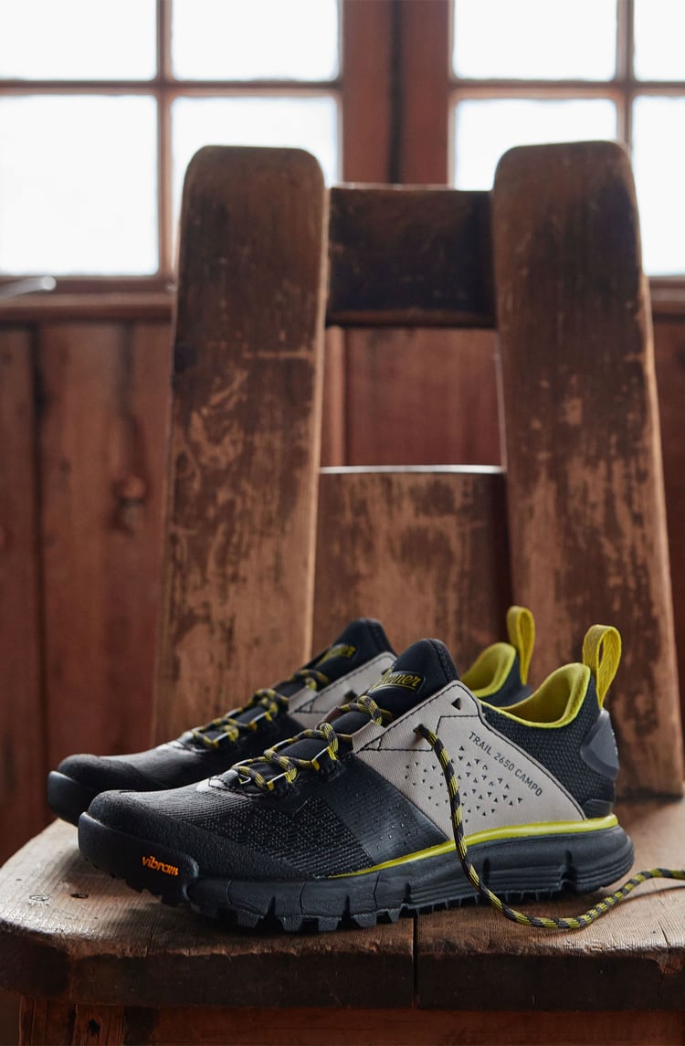 A pair of hiking shoes in black, white, and yellow