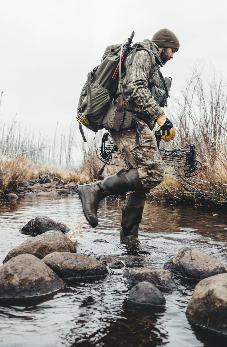 Walking through the woods in knee high camo boots