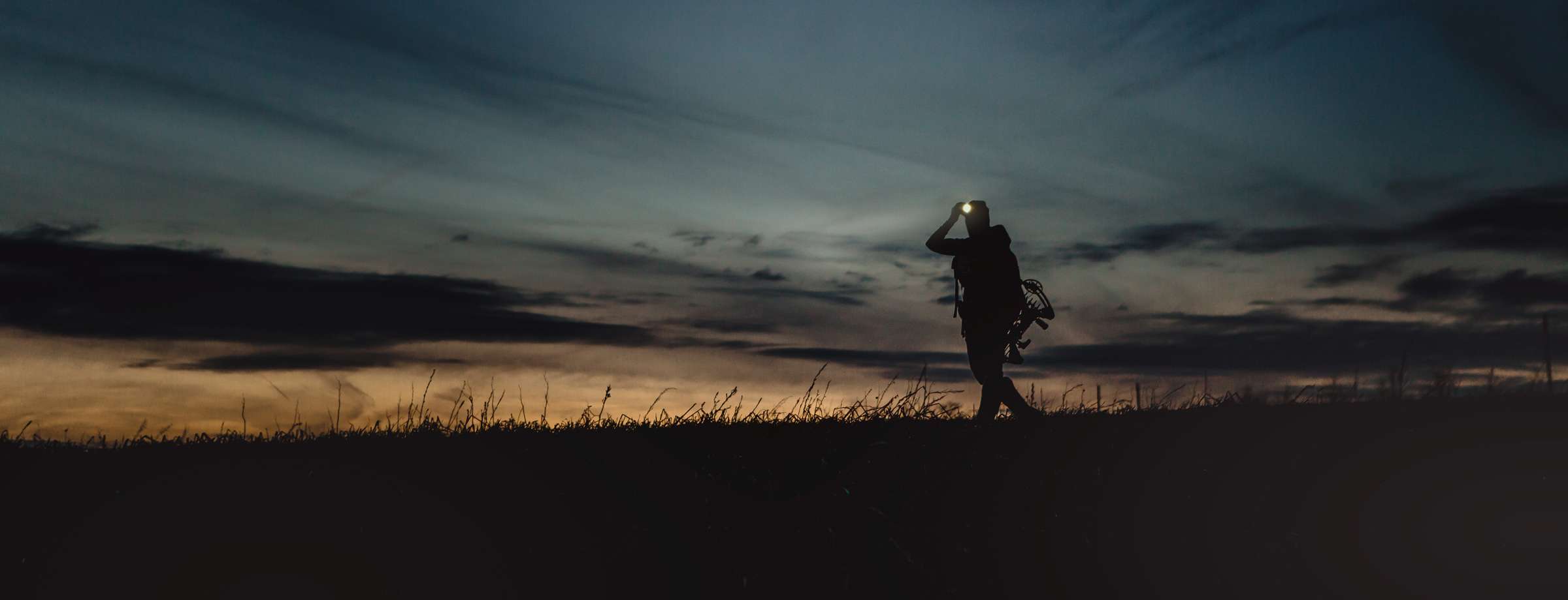 A man in gray boots ascending a tree