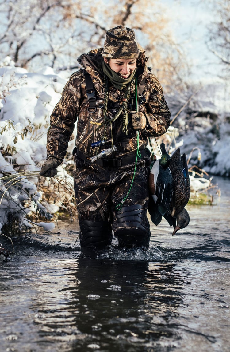 A man in gray boots ascending a tree