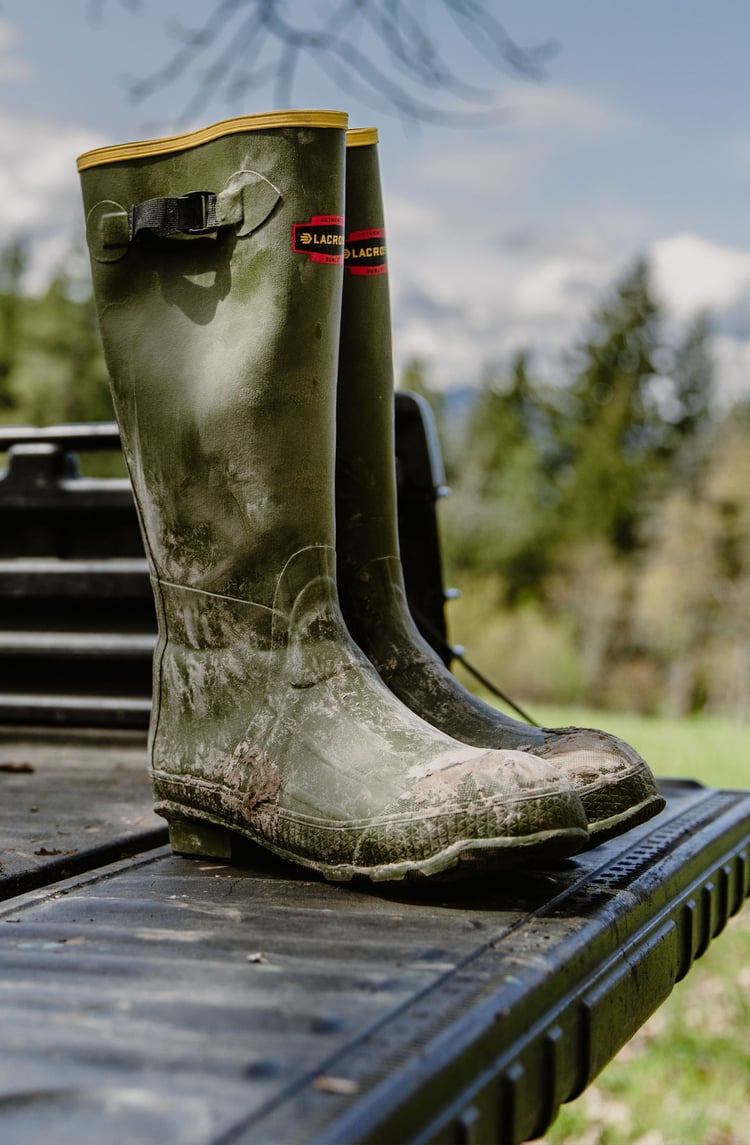 A man in gray boots ascending a tree