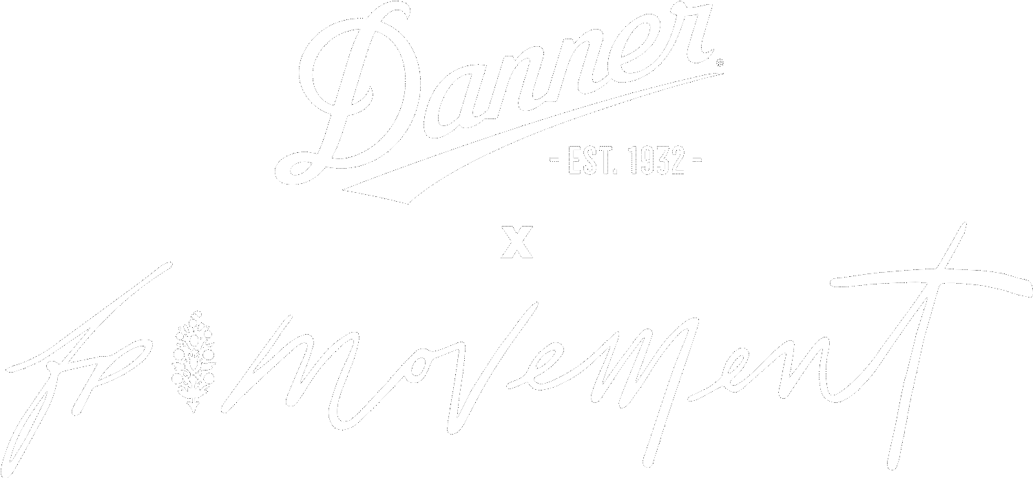 Image of blue hiking boots with orange and magenta accents hanging from shoe laces against a blue background