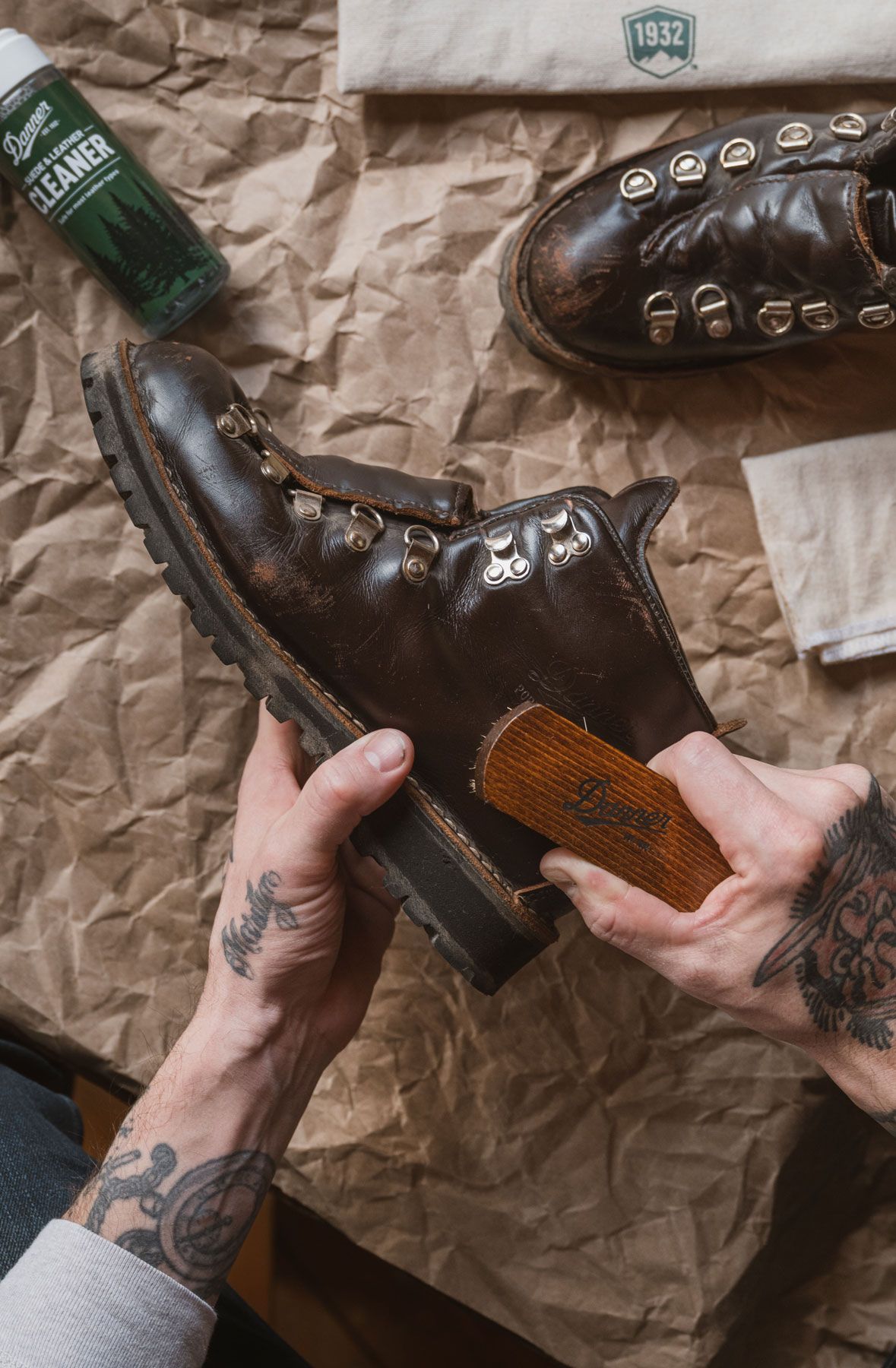 A woman hiking through an open field with rocks in the background