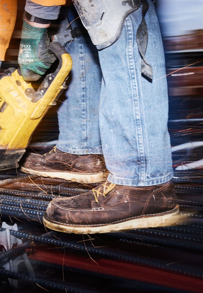 a pair of work boots with a moc toe design