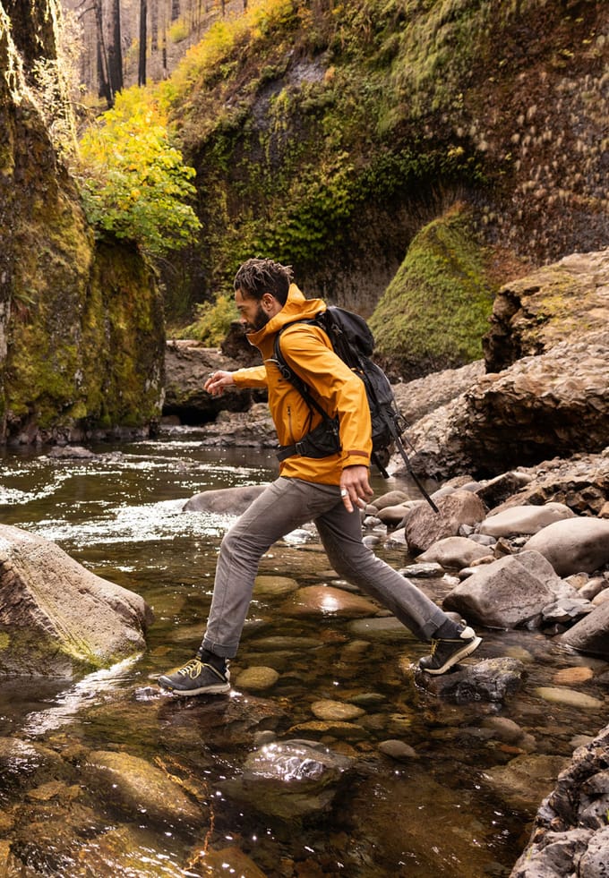 man crossing stream