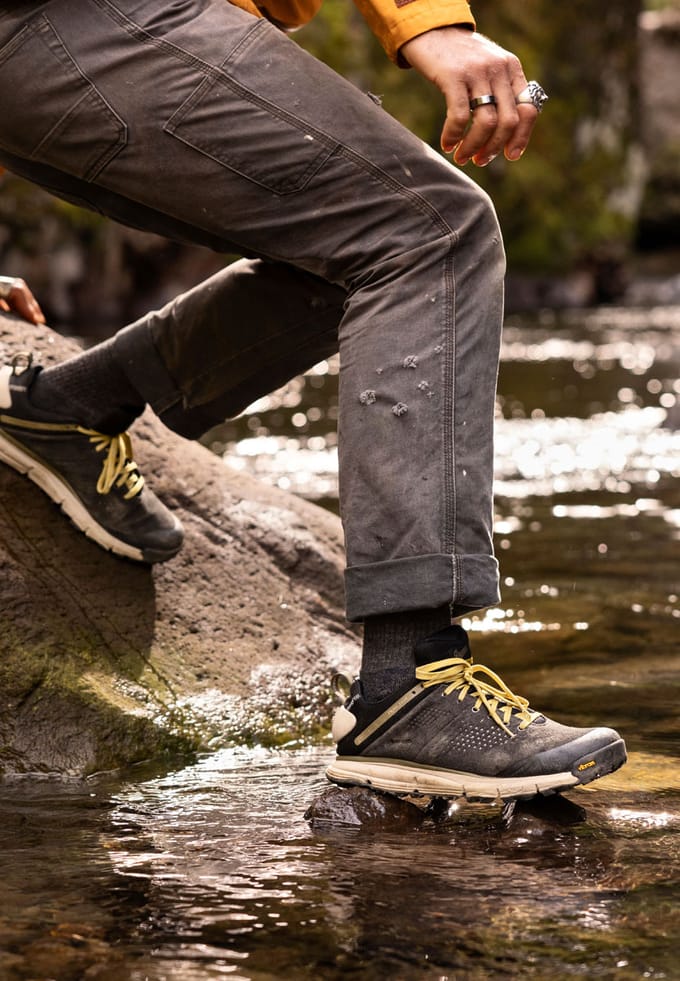 closeup of a hiking shoe above a stream