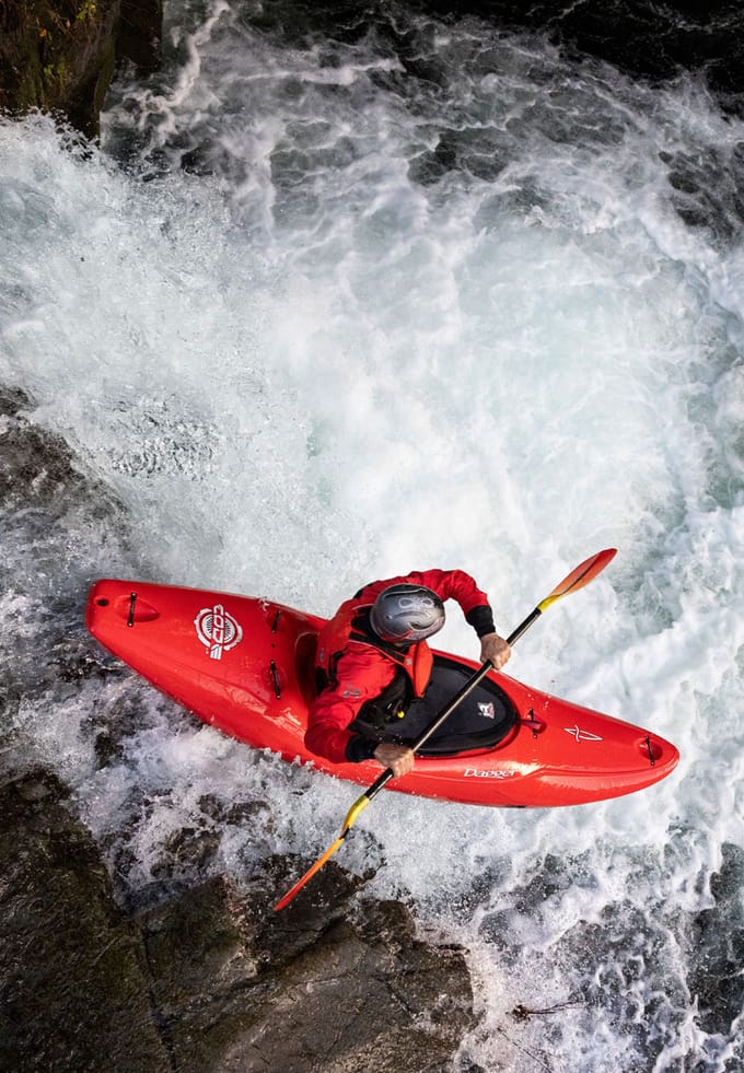 kayaker going down a waterfall