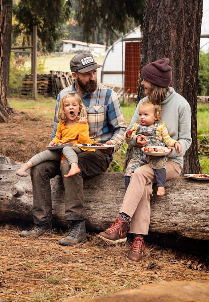 Couple with children sitting on a log