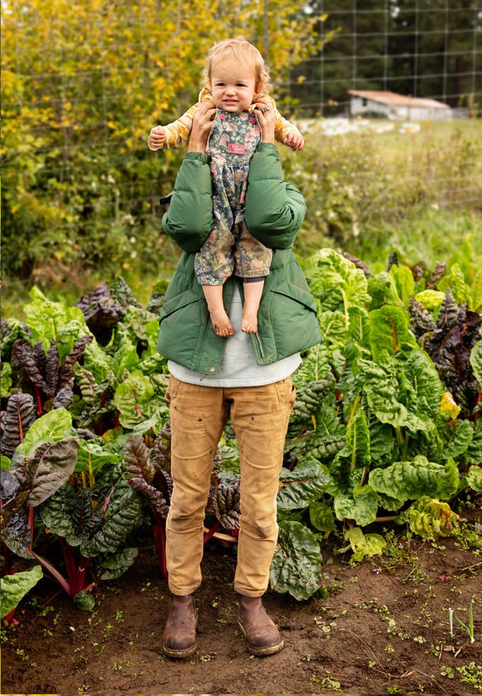 a parent holds up their child to the camera