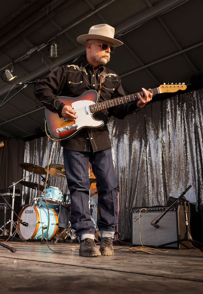a man plays guitar on stage