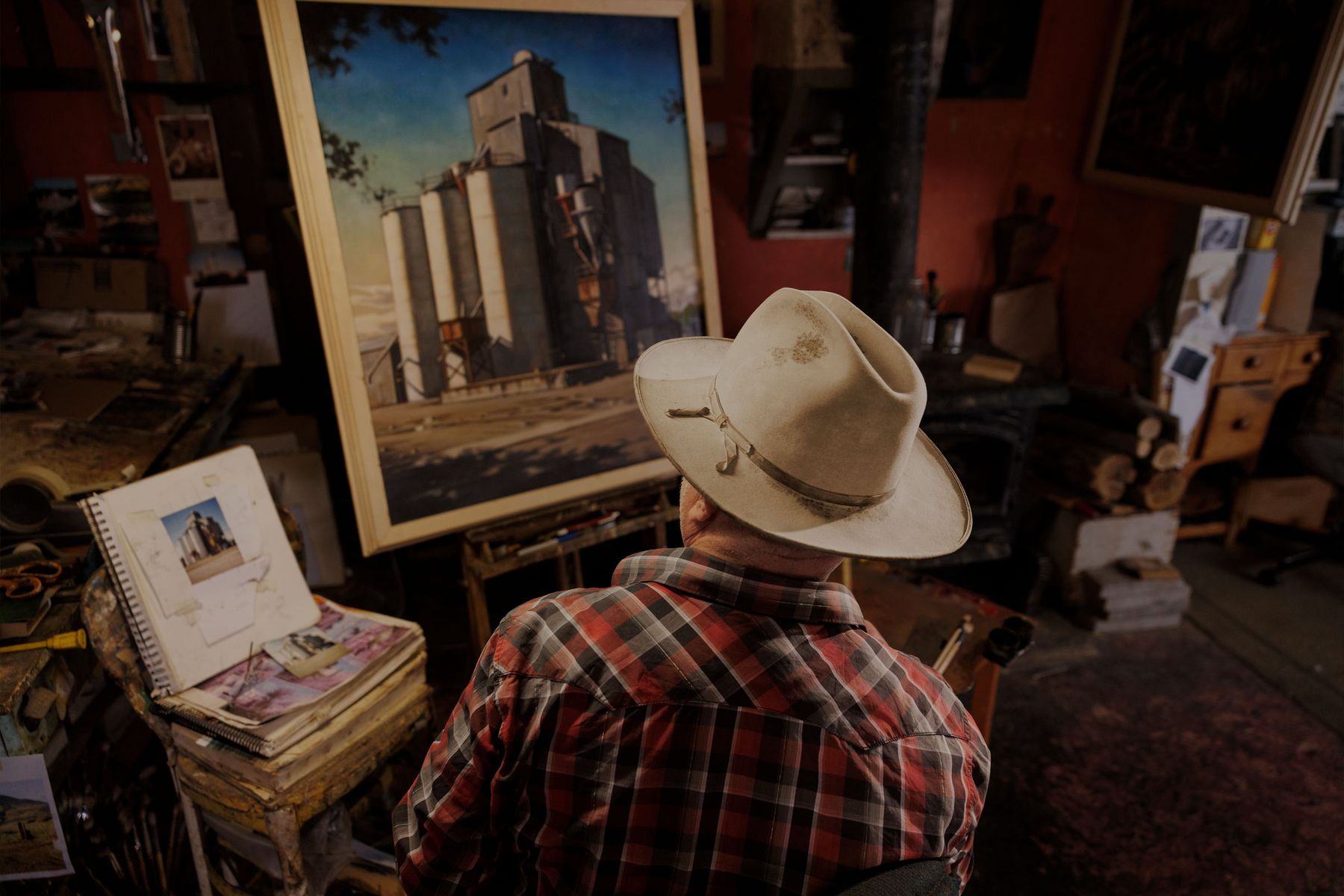man painting on an easel