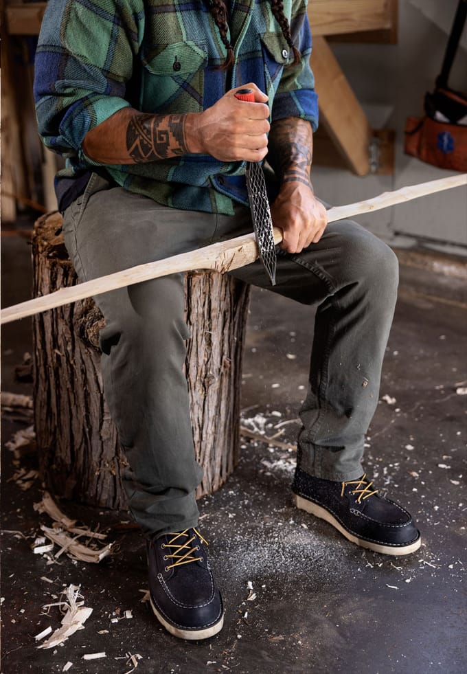 A man carving a bow