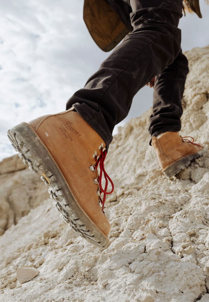 pair of brown and red hiking boots ascending
