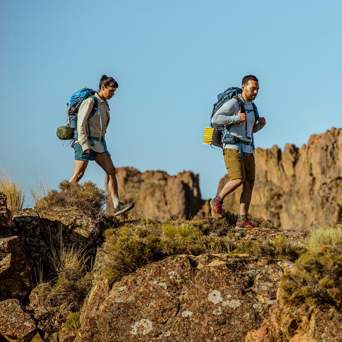 A hiker ascending some rocks in a low top hiking shoe