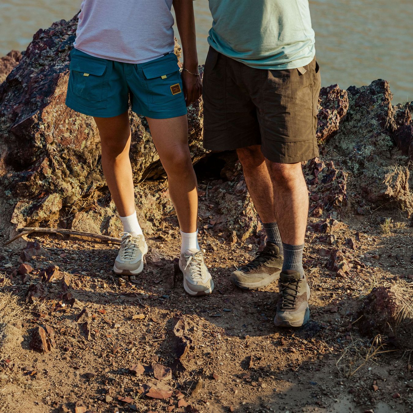 A hiker ascending some rocks in a low top hiking shoe