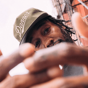 a pair of brown work boots with orange accents