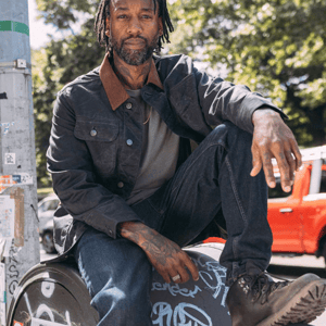 a pair of brown work boots with orange accents