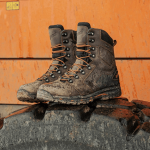 a pair of brown work boots with orange accents