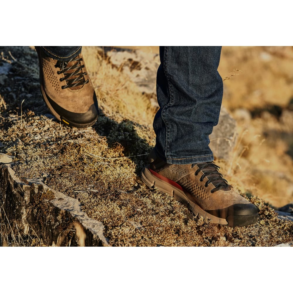 Lower body view of hiker walking on a rugged mountain trail