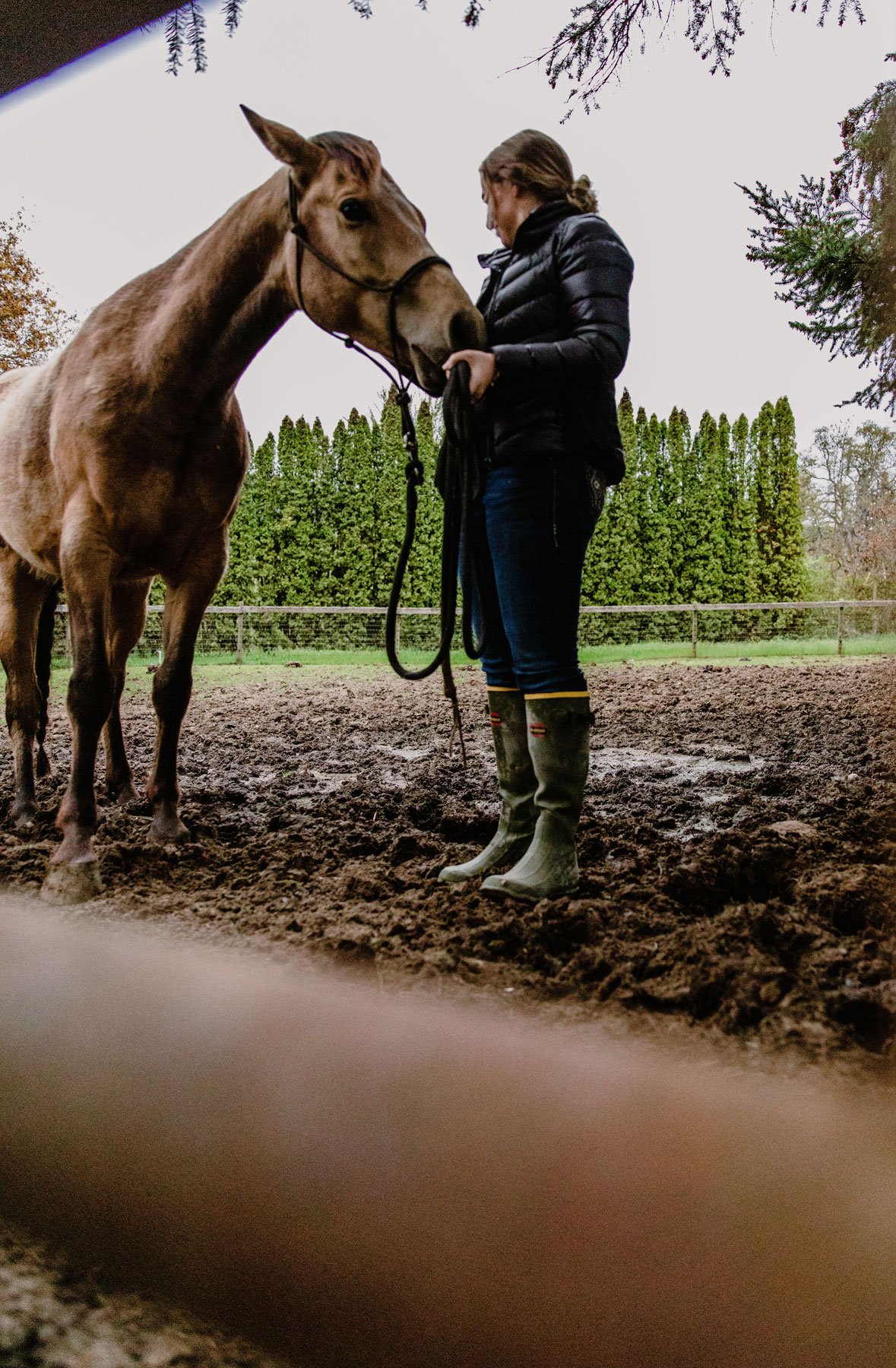A man in gray boots ascending a tree