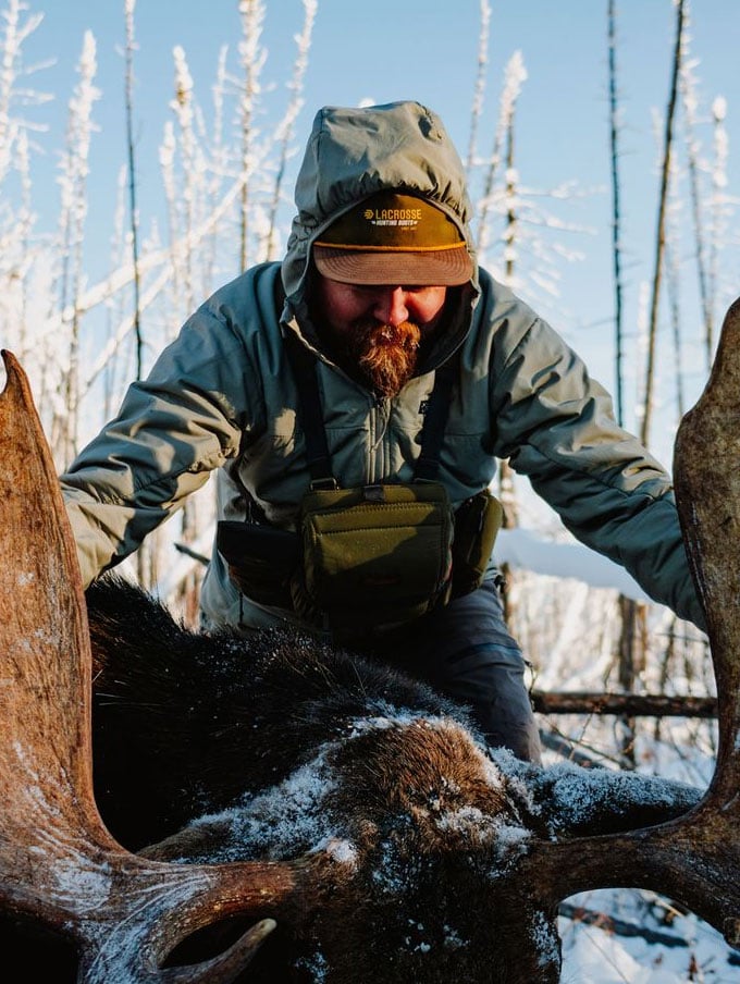 A stone colored pair of ankle high rubber boots is shown getting into a vehicle