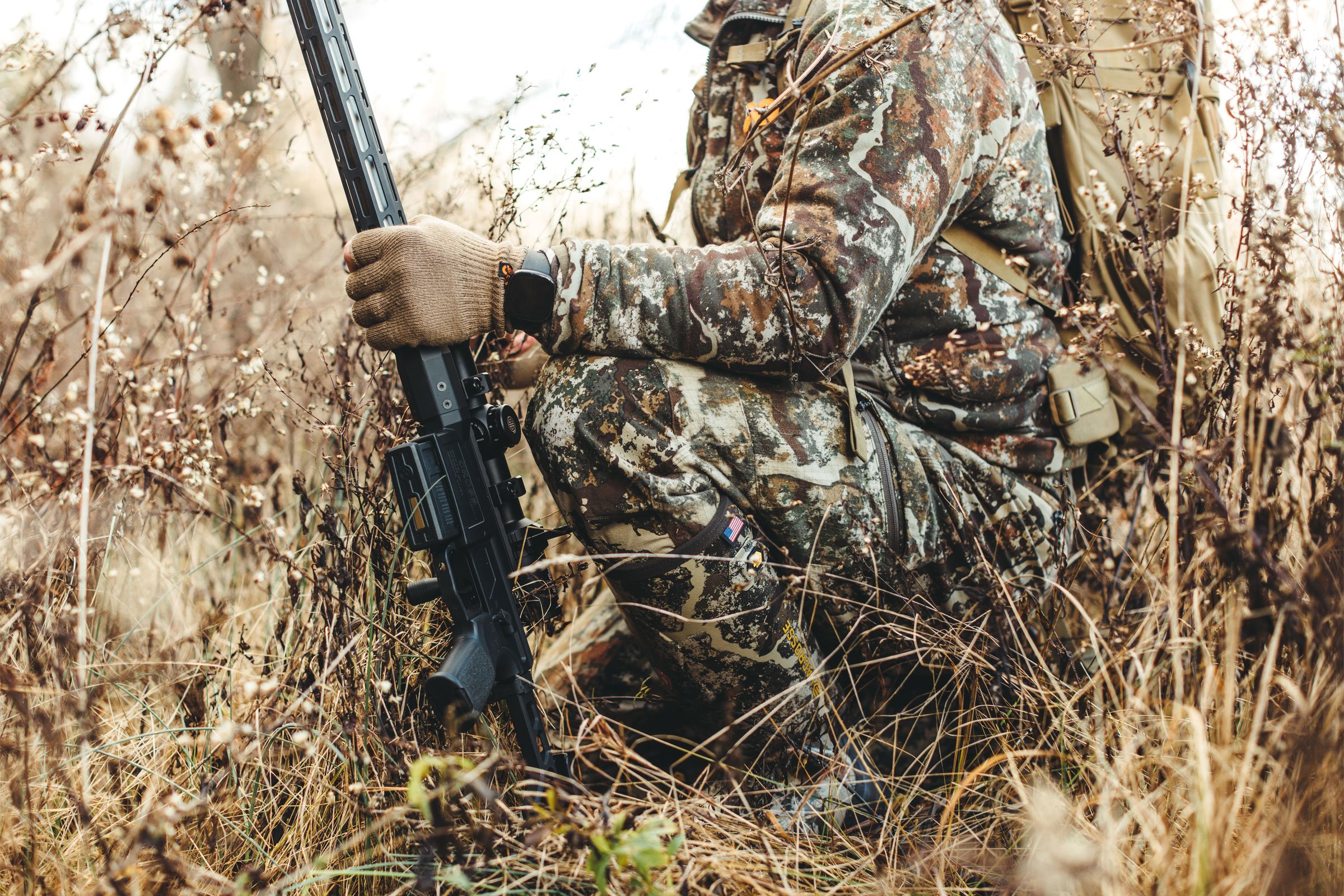 hunter walking through trees