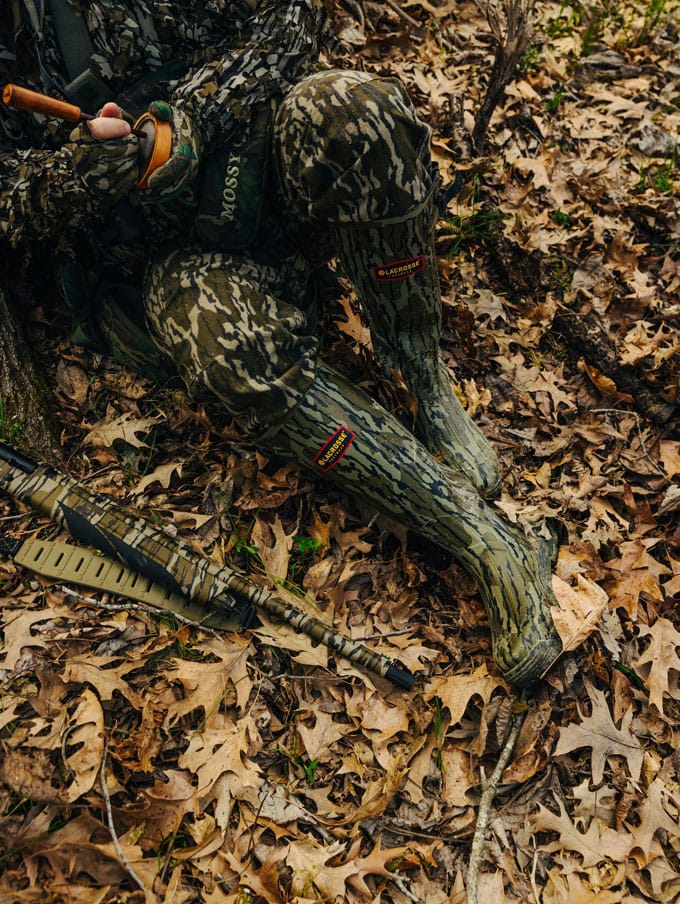 A stone colored pair of ankle high rubber boots is shown getting into a vehicle
