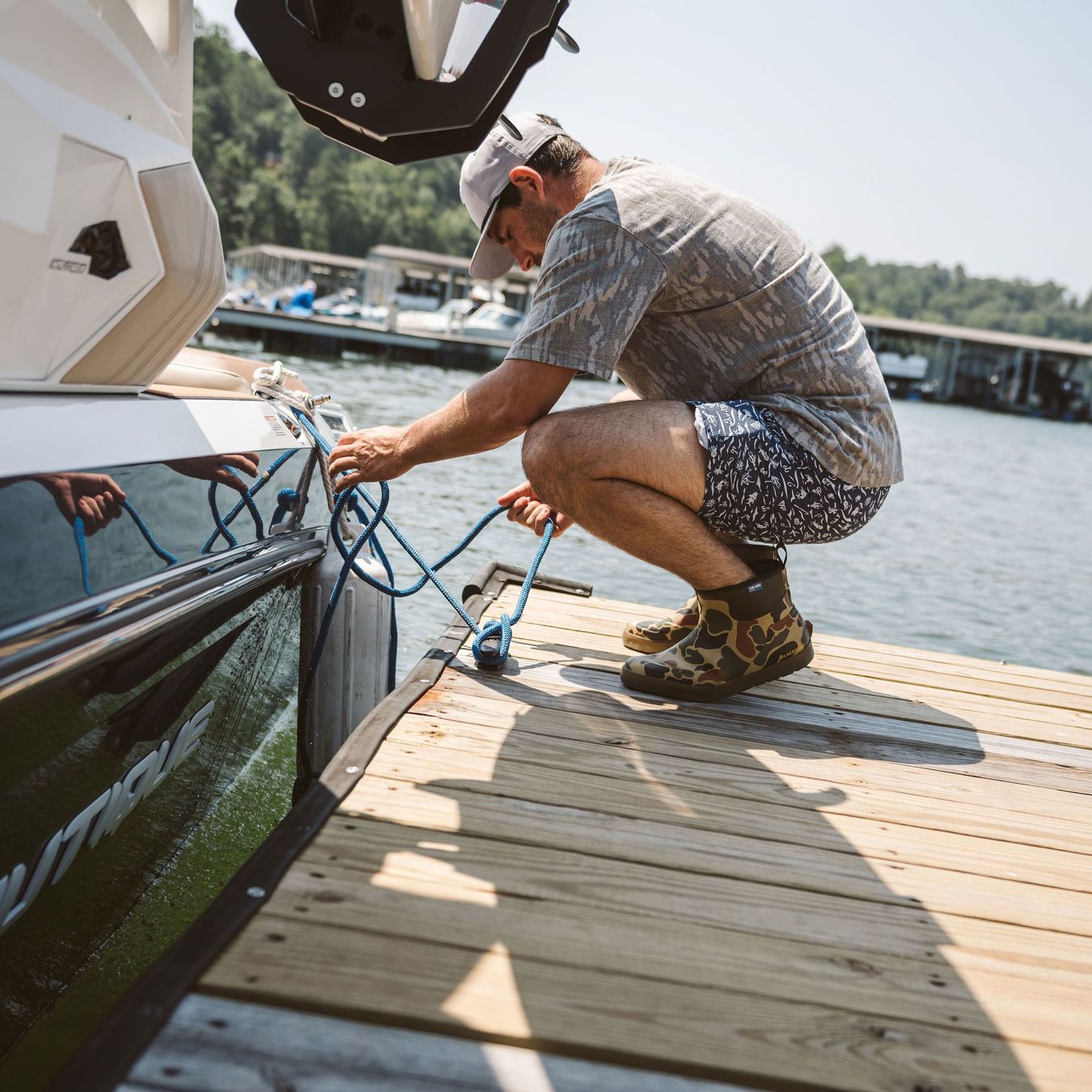 a man wearing short rubber boots in a duck camo