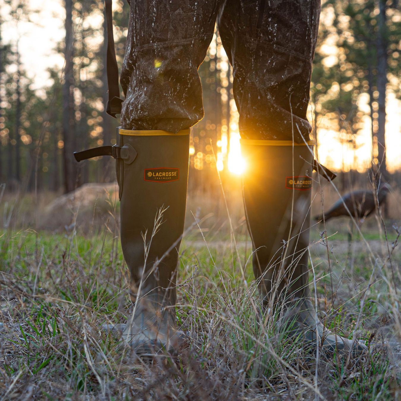 a camo rubber boot cuts through water