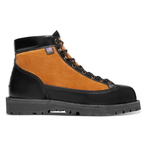 A muted brown leather boot shown in profile view with dirt smudges on the light gray midsole and side of the boot.